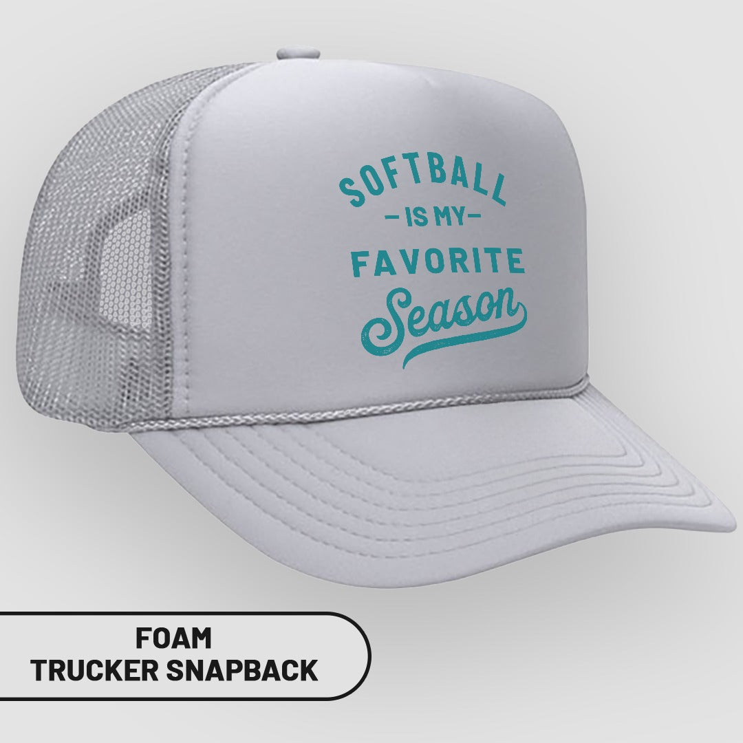 White foam trucker snapback hat with teal text "Softball is my favorite season".